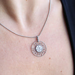 Someone wearing the Morgana's Spell Sterling Silver Necklace with a black top.