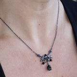 Someone wearing the Dark Fae Brass Plated Necklace with a black tank.