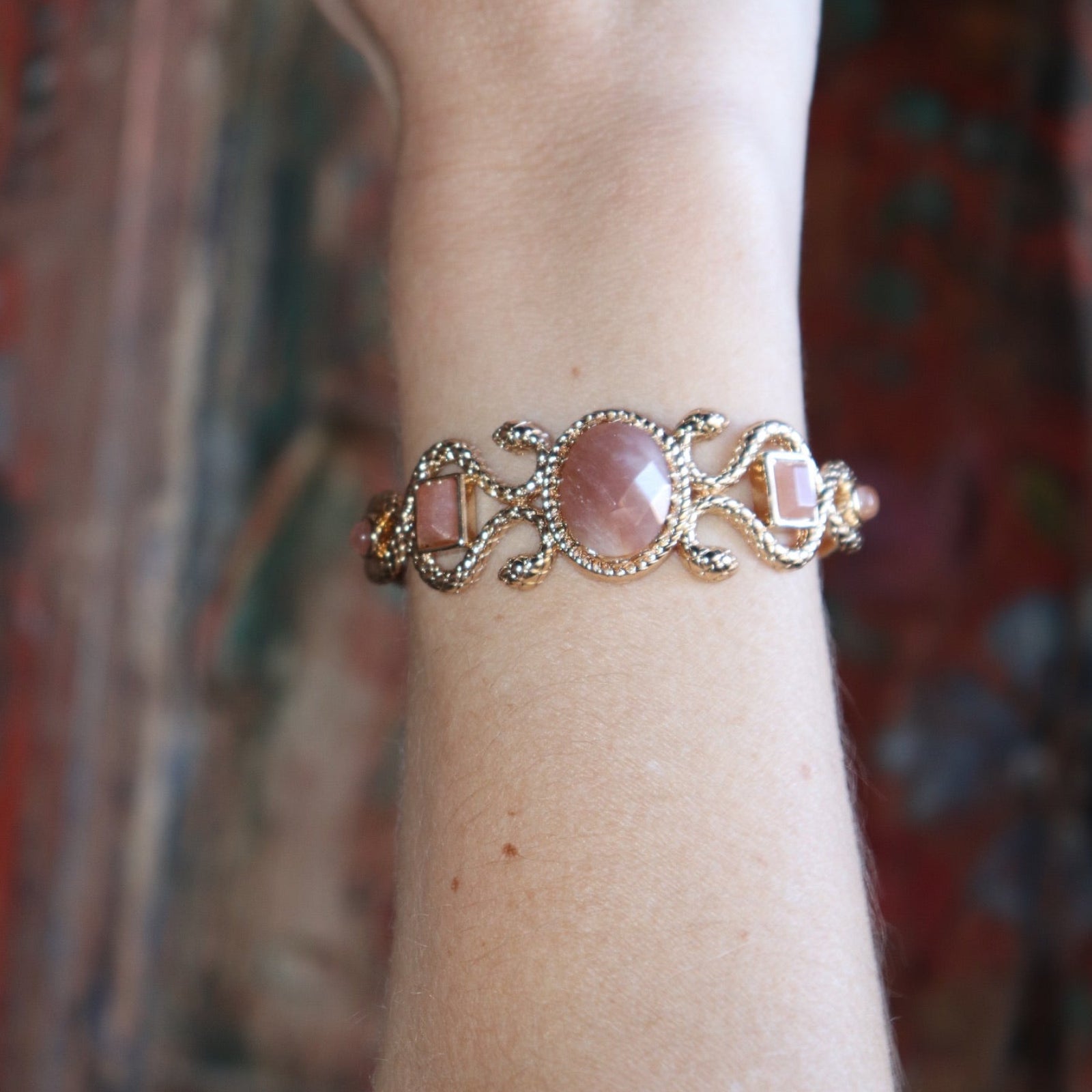 Someone wearing the Gold Medusa Cuff Bracelet.