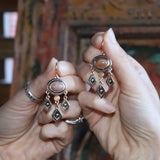 Someone holding the Gold Temple Sunstone Dangle Earrings.