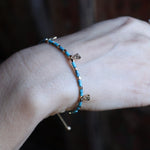 Someone wearing the Temple of Philae Adjustable Bracelet.