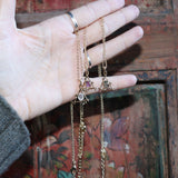 Someone holding all three of the Fae Crystal Gold Necklaces.