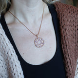 Someone wearing the Morgan Le Fay Gold Necklace with a black tank.