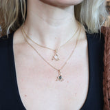 A woman wearing the quartz and labradorite Fae Crystal Gold Necklaces.