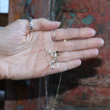 Someone holding the Fairy Glen Gold Necklace.