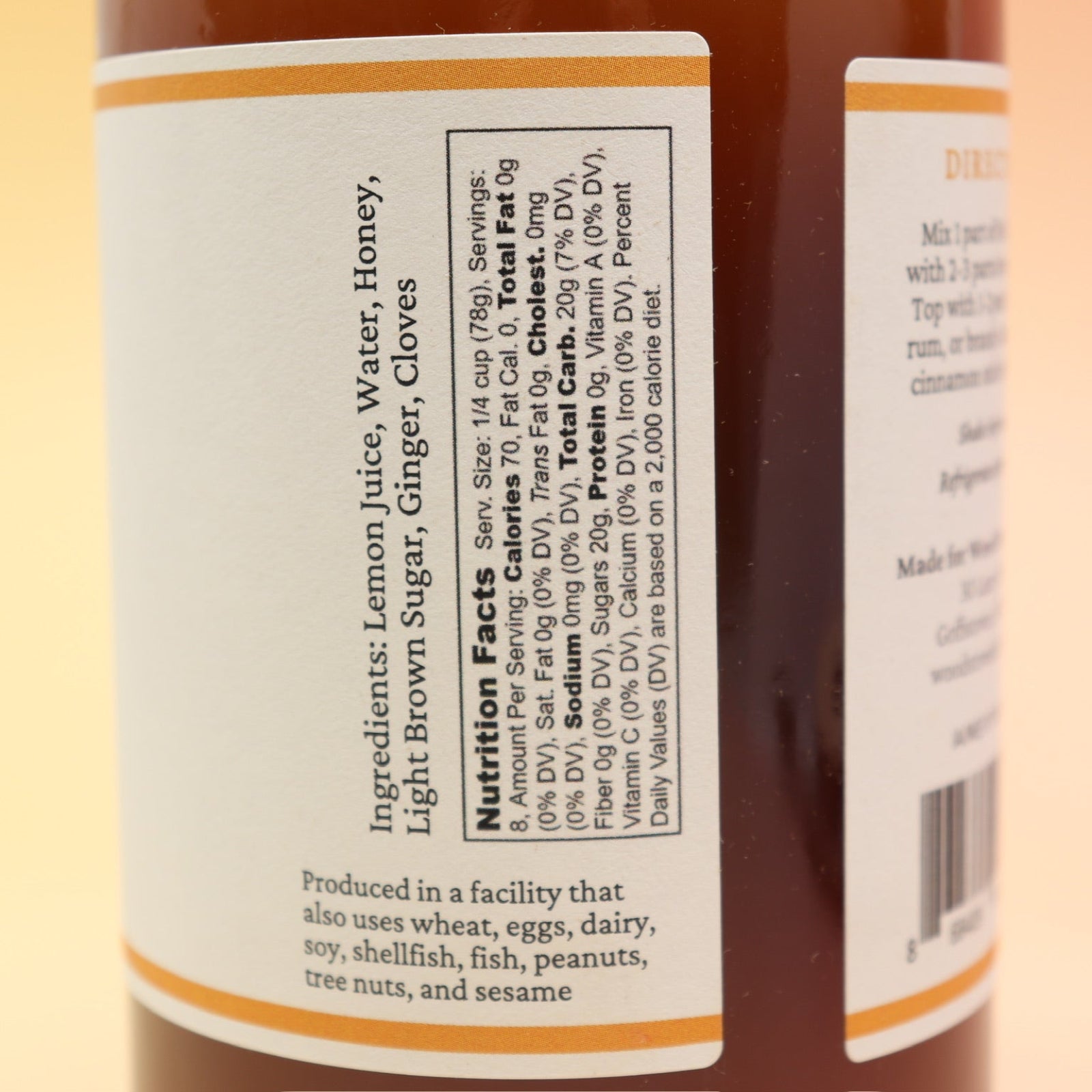 The Hot Toddy Cocktail Mixer and Mocktail Mixer on a pink and yellow background.