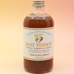 The Hot Toddy Cocktail Mixer and Mocktail Mixer on a pink and yellow background.