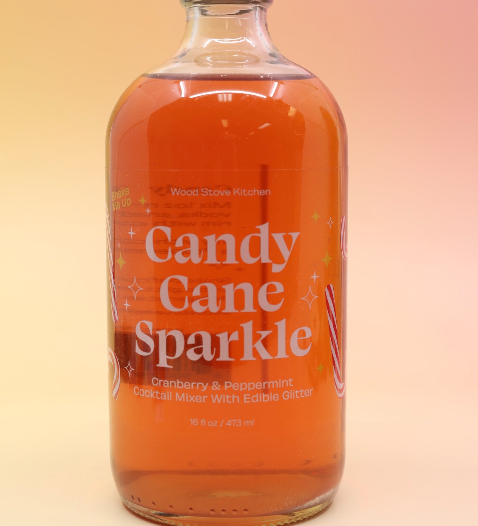 The Candy Cane Sparkle Cocktail & Mocktail Mixer on a pink and yellow background.