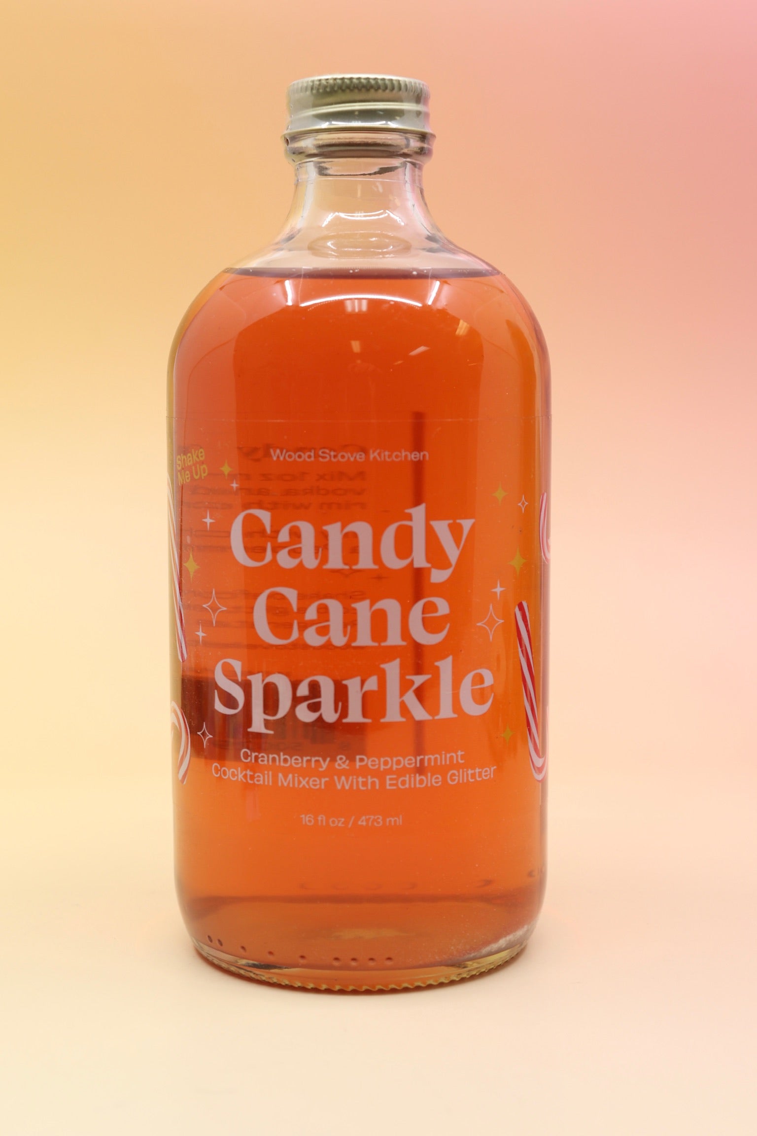 The Candy Cane Sparkle Cocktail & Mocktail Mixer on a pink and yellow background.