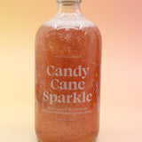 The Candy Cane Sparkle Cocktail & Mocktail Mixer on a pink and yellow background.