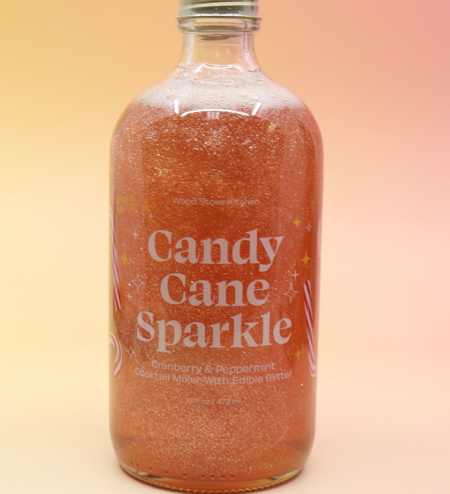 The Candy Cane Sparkle Cocktail & Mocktail Mixer on a pink and yellow background.