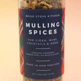 The Mulling Spices bottle on a pink and yellow background.