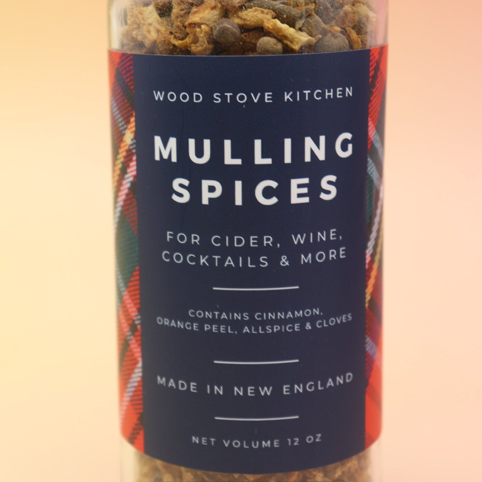 The Mulling Spices bottle on a pink and yellow background.