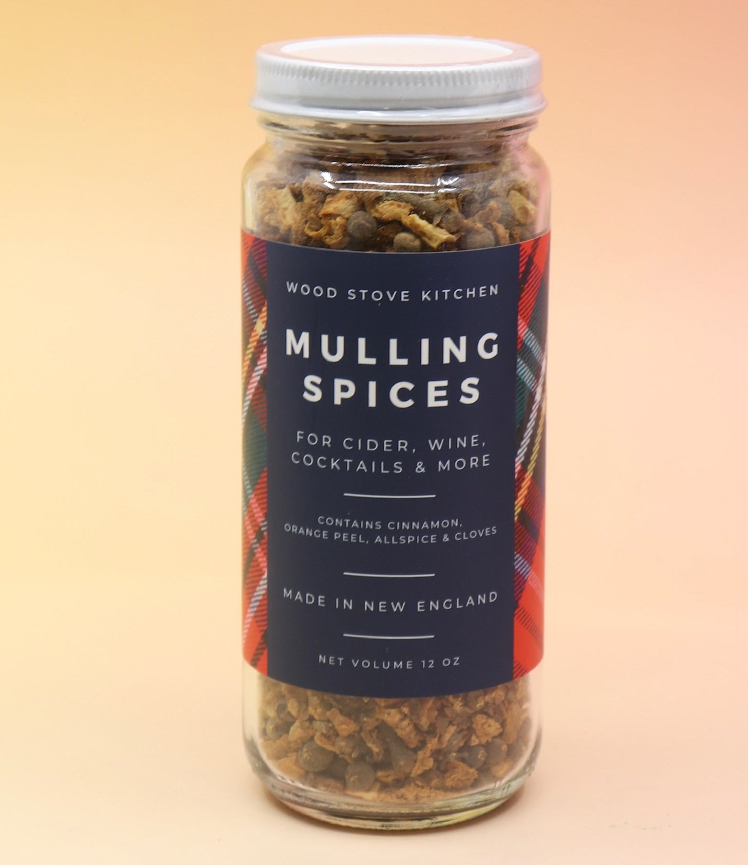 The Mulling Spices bottle on a pink and yellow background.