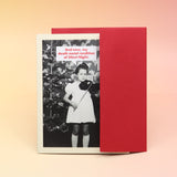 The Death Metal Christmas Card with its envelope on a pink and yellow background.