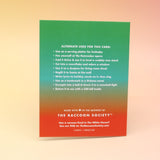 The back of the Have a Serene Christmas Card on a pink and yellow background.