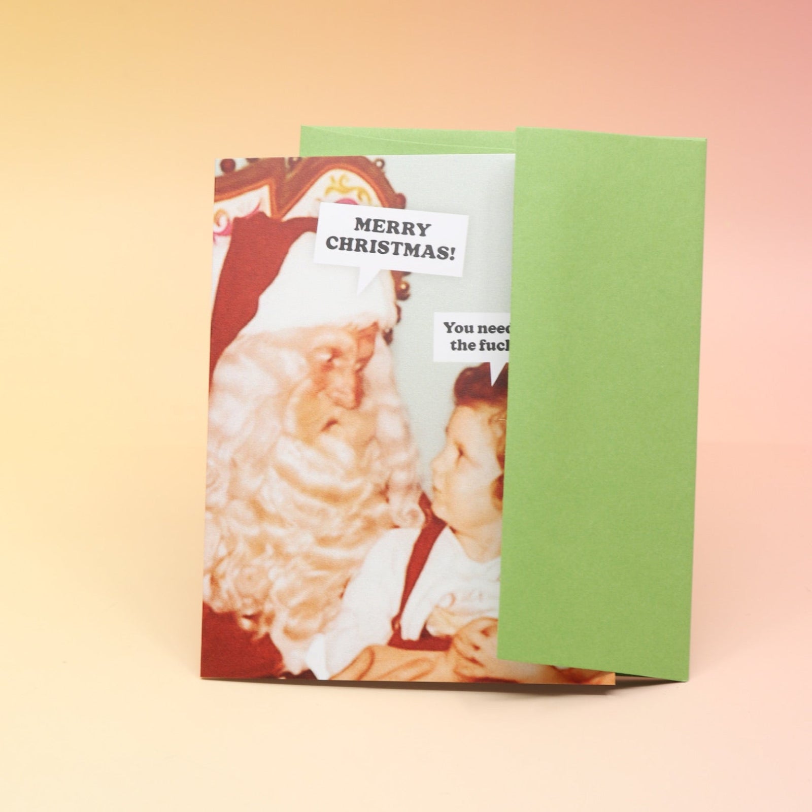 The Calm the F*ck Down Christmas Card and its envelope on a pink and yellow background.