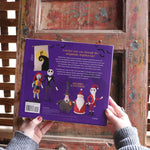 Someone holding the The Nightmare Before Christmas Inspired Crochet Kit in front of a wooden background, showing off the back.