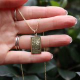 Someone holding the Star Tarot Gold Necklace.