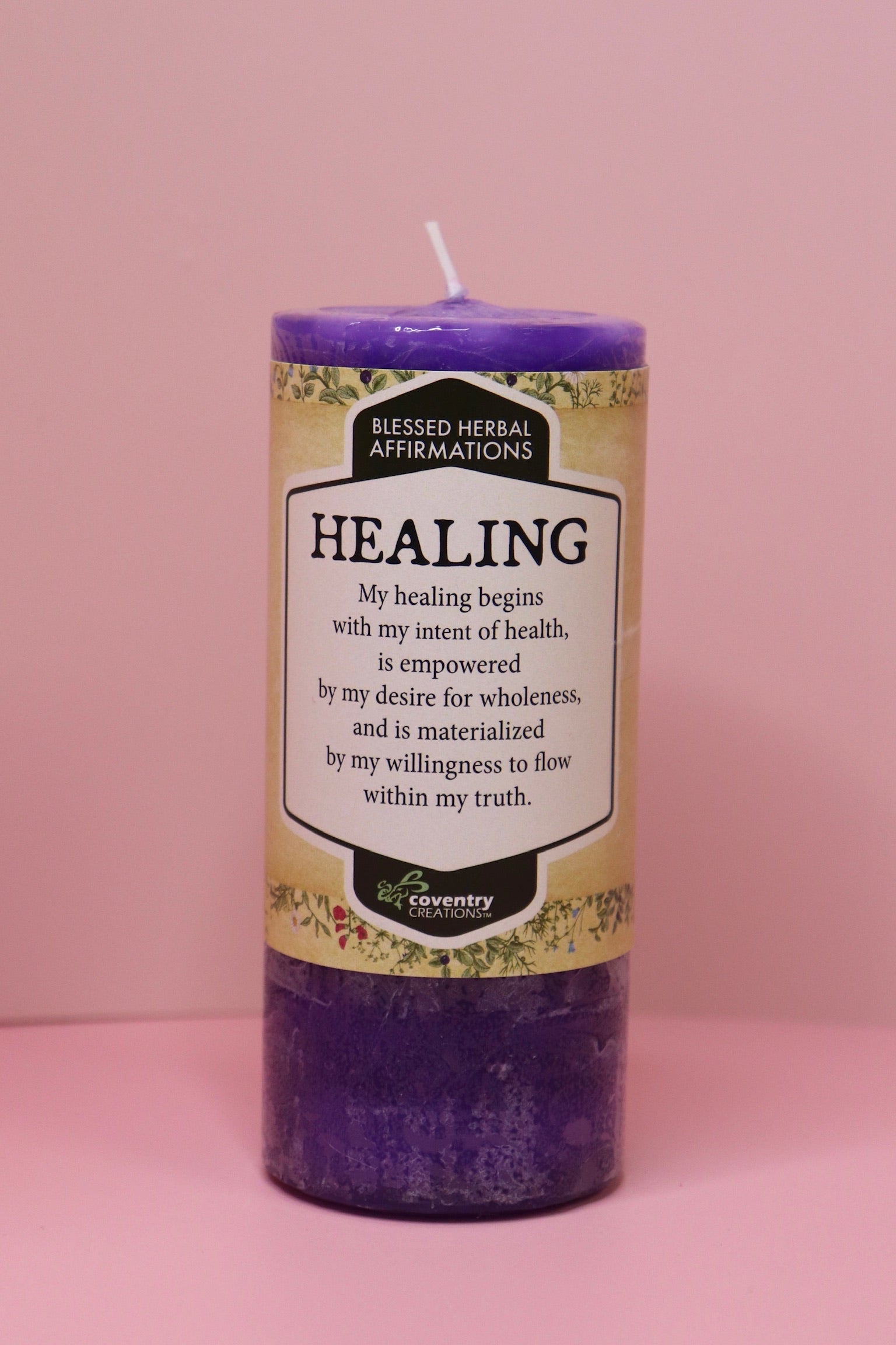 The Affirmation Healing - Pillar Candle with Honeysuckle & Cedar on a pink background.