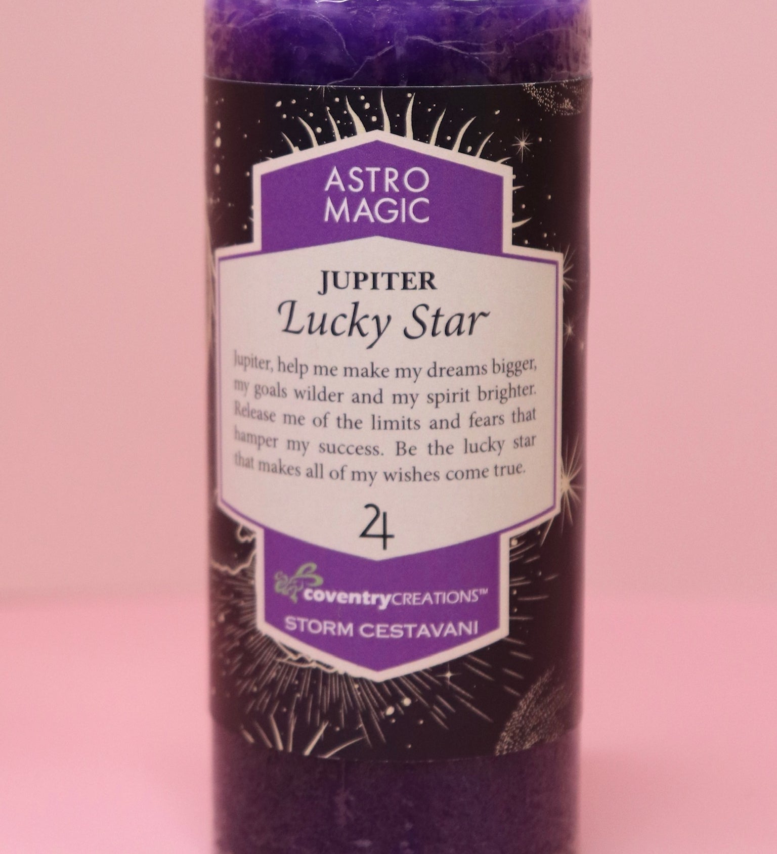 The Astro Magic Jupiter - Lucky Star Pillar Candle on a pink background.