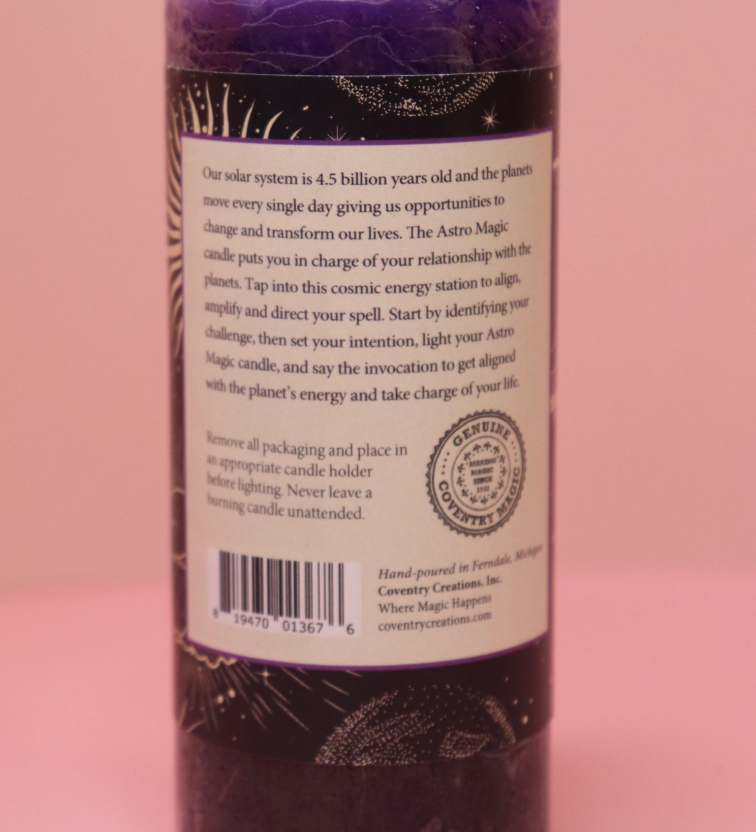 The back of the Astro Magic Jupiter - Lucky Star Pillar Candle on a pink background.