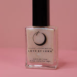 The Full Moon Nail Polish on a pink background.