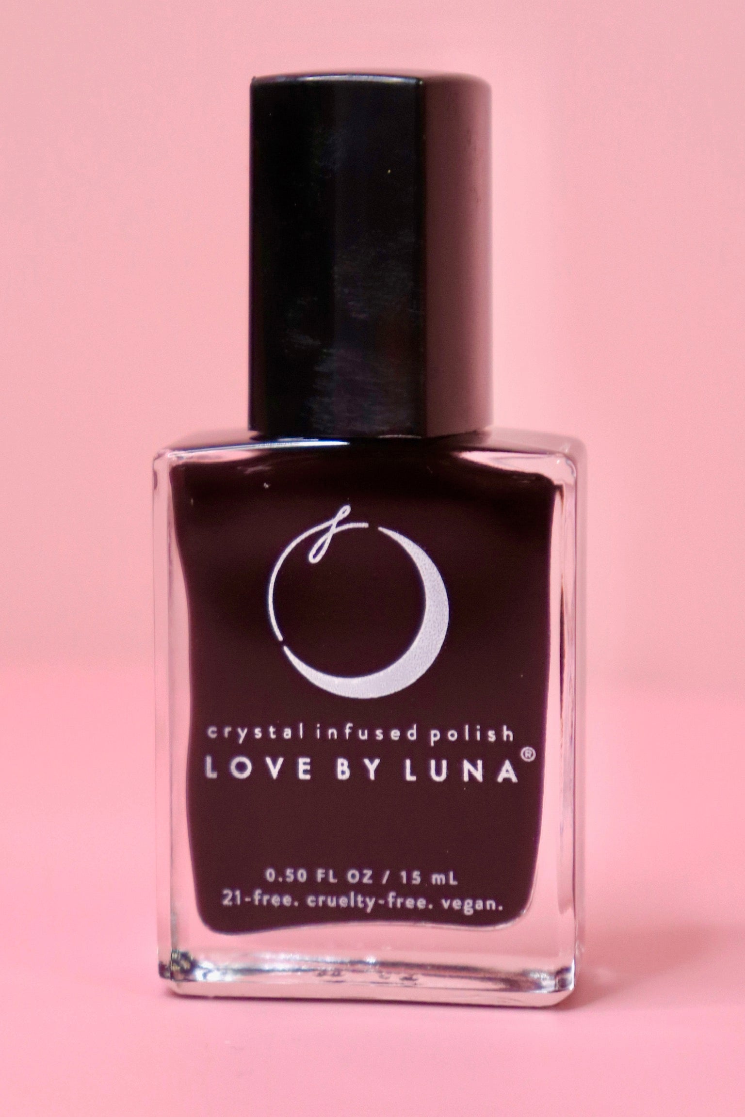 The Capricorn Zodiac Nail Polish with Micronized Garnet on a pink background.