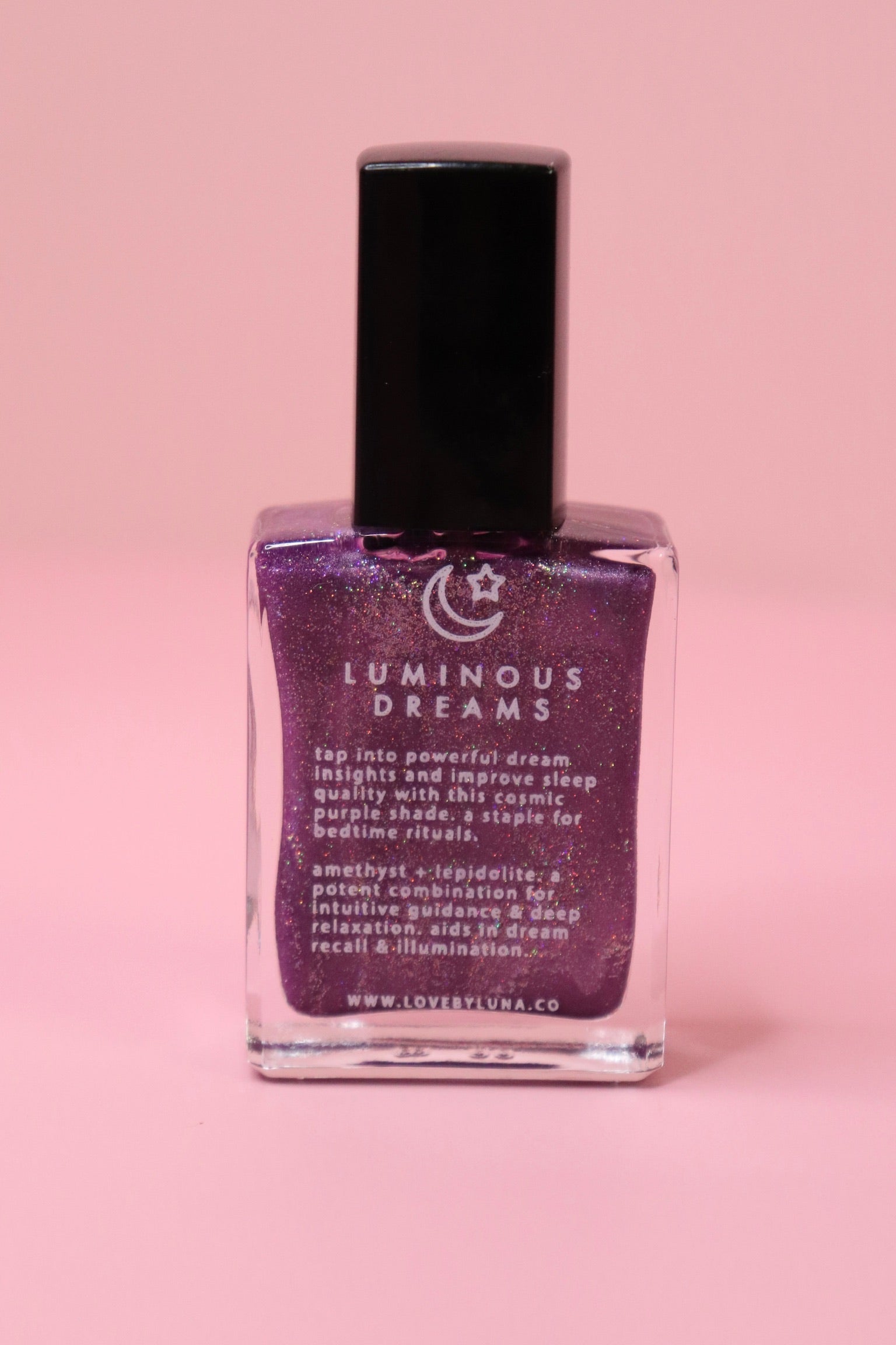 The Luminous Dreams Nail Polish with Micronized Amethyst on a pink background.