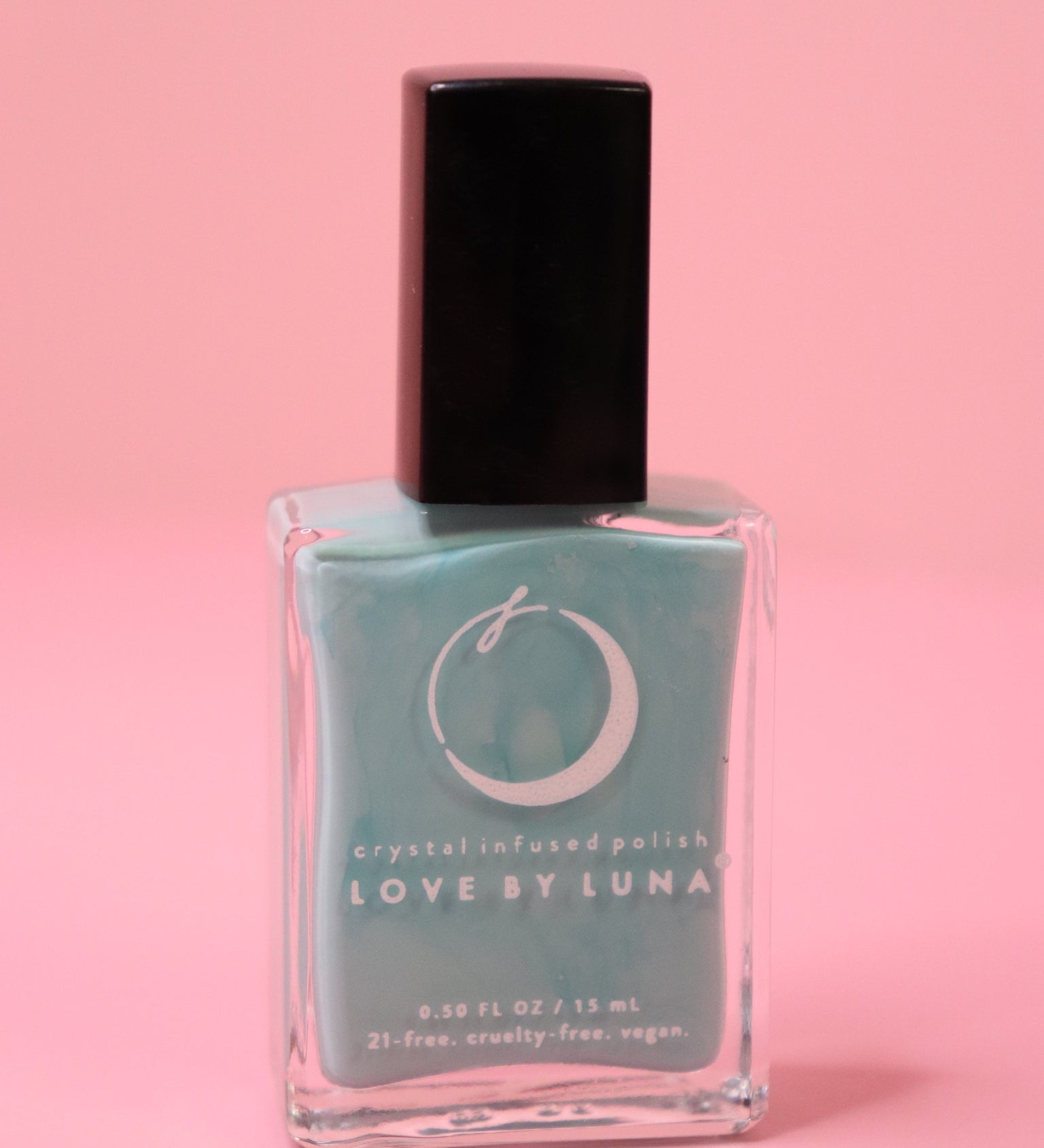 The Fearless Flow Nail Polish with Micronized Aquamarine on a pink background.