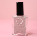 The Virgo Zodiac Nail Polish with Micronized Amazonite on a pink background.