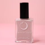 The Virgo Zodiac Nail Polish with Micronized Amazonite on a pink background.