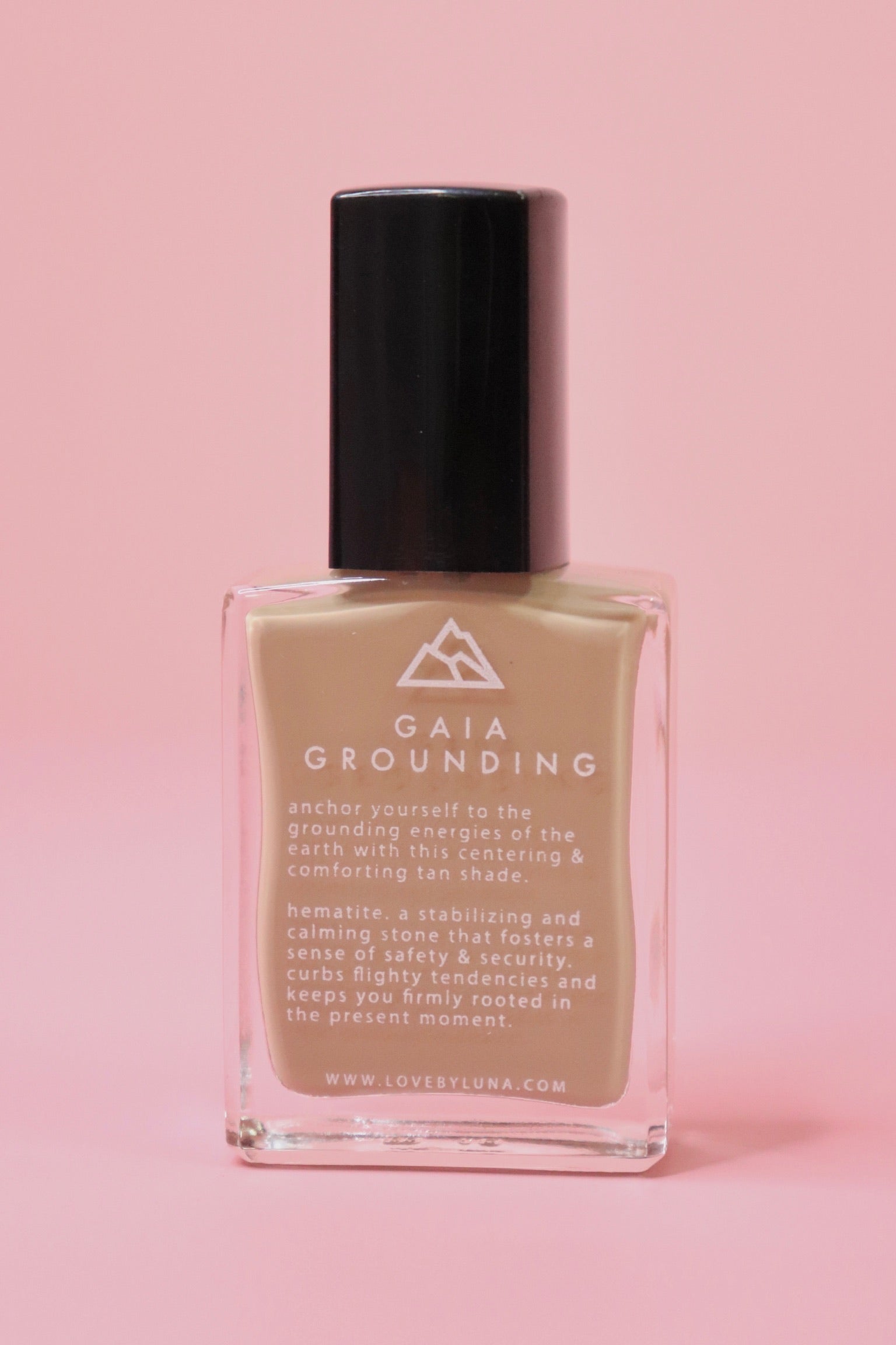 The Gaia Grounding Nail Polish with Micronized Hematite on a pink background.