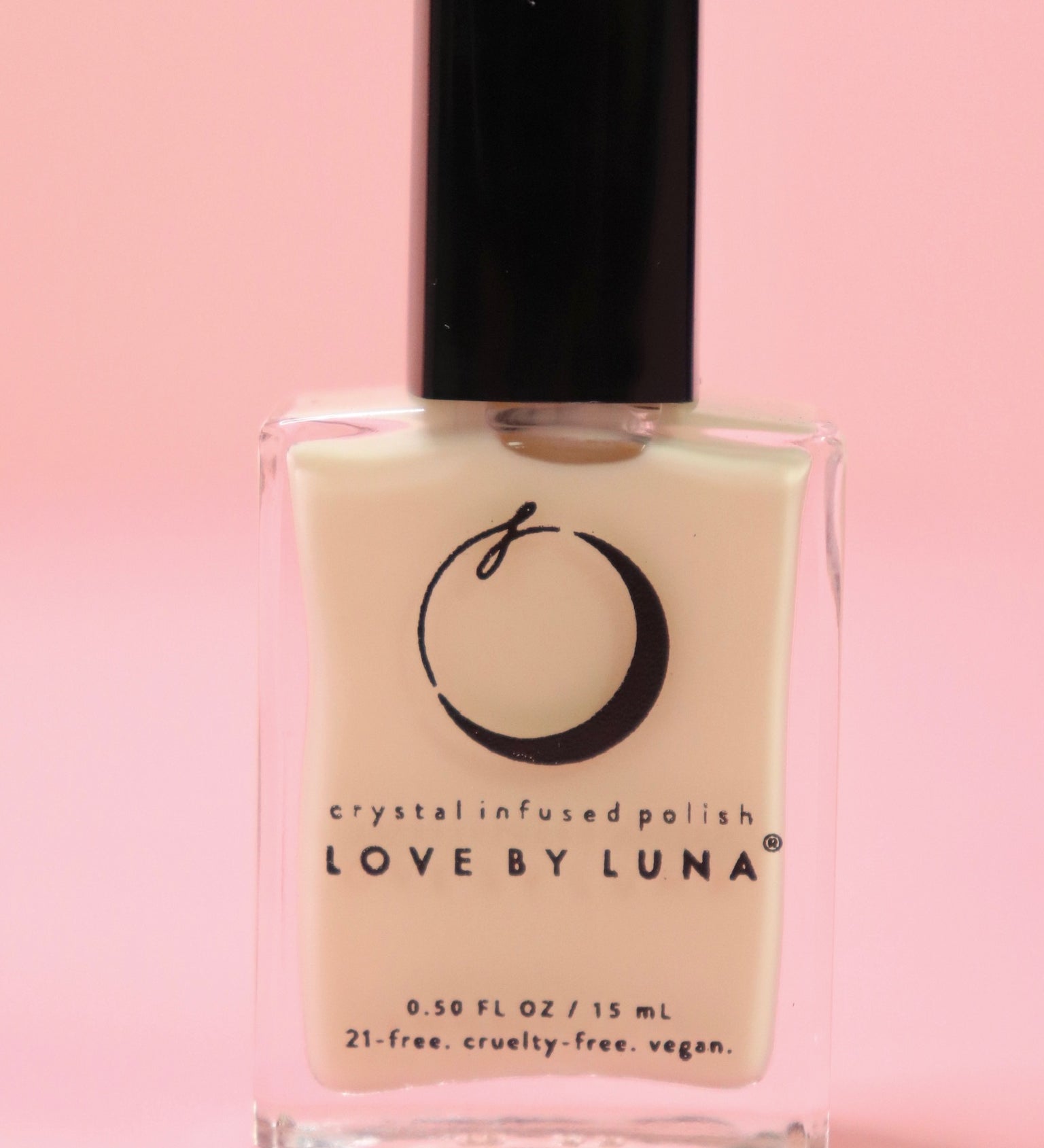 The Goddess Nail Polish with Micronized Rose Quartz, Selenite, & Moonstone on a pink background.