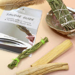 The contents of the 'Soul Sticks' Smudging Starter Kit with Guide and Rosemary Sage on a pink and yellow background.