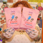 A woman holding the Pippi Longstocking Gold Coins bags.