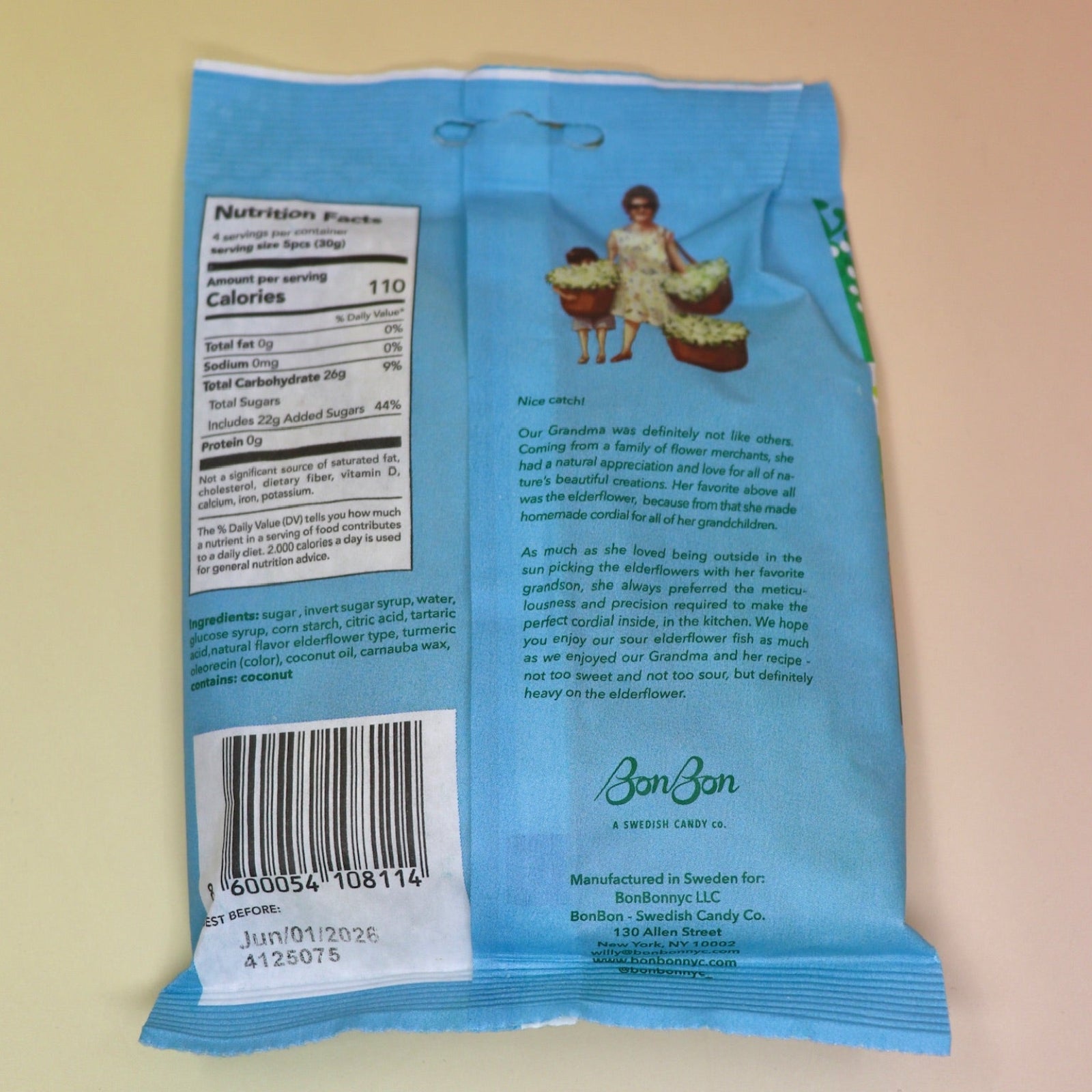 A bag of the BonBon NYC Sour Elderflower Fish - Swedish Candy on a pink and yellow background.