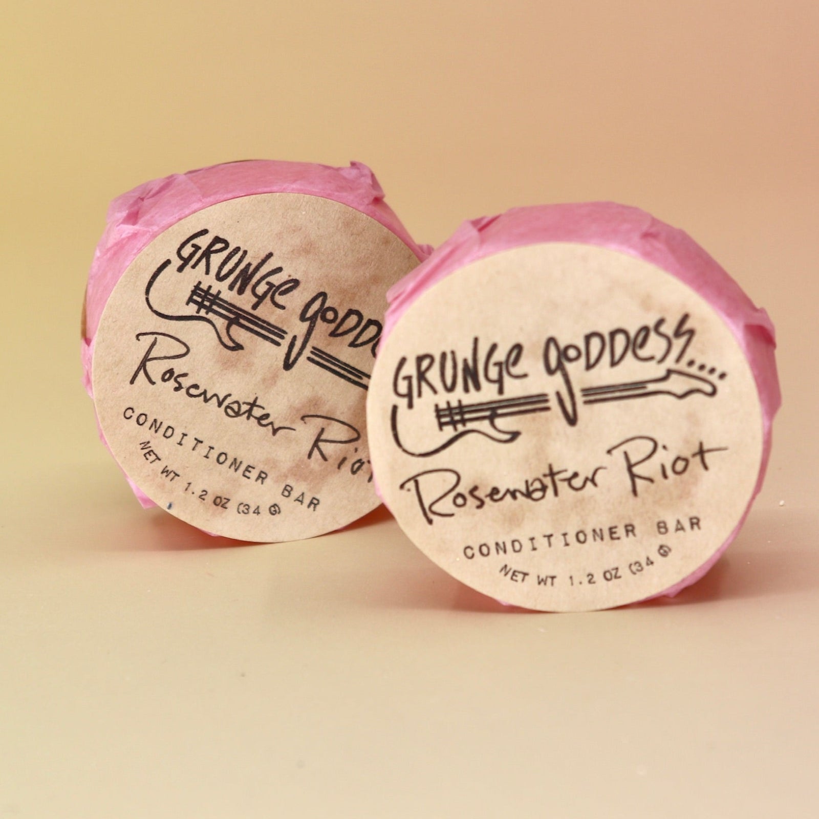 Two of the Rosewater Riot - Conditioner Bars on a peach-colored background.