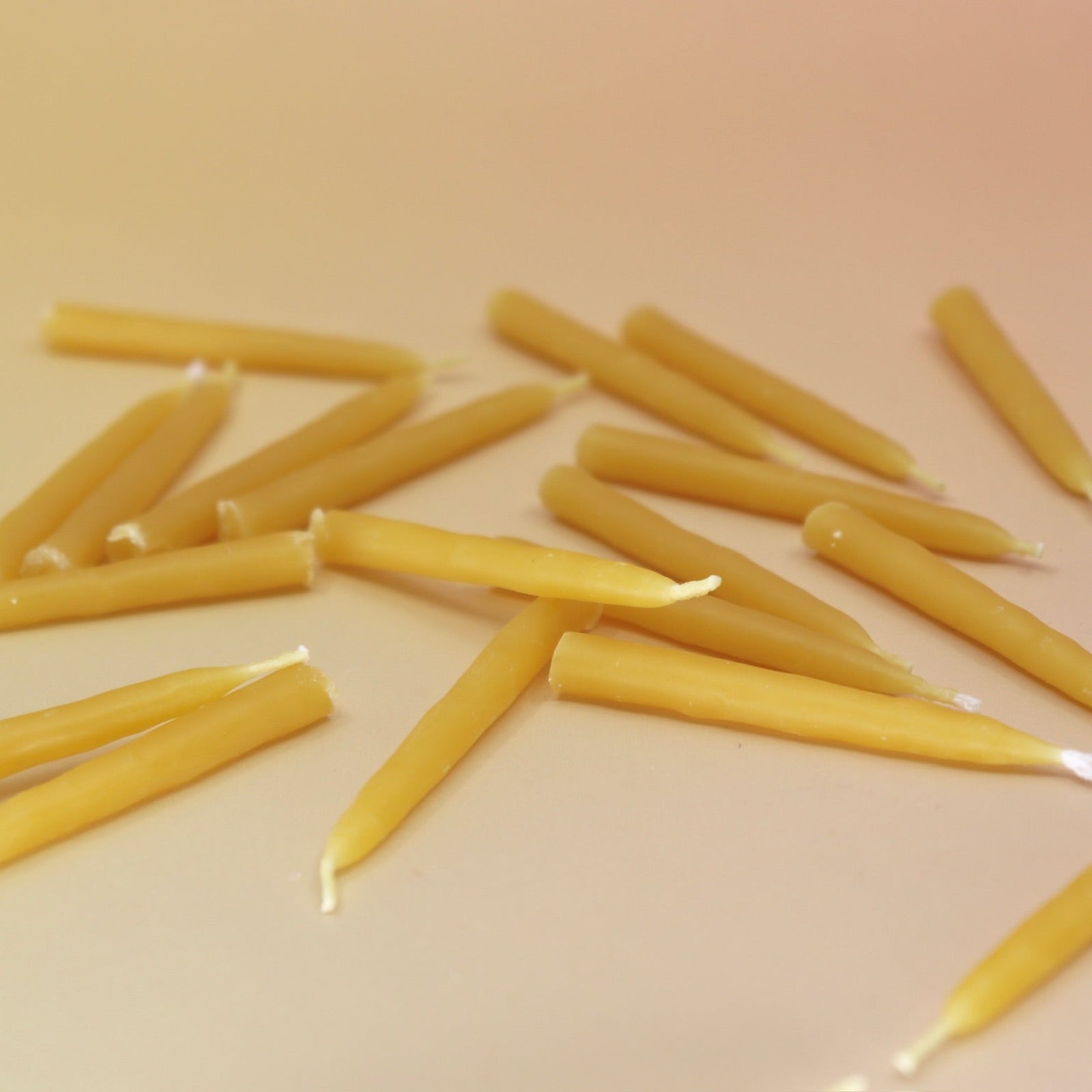The 20 Minute Beeswax Candle Set: Mindful (Set of 20) on a light pink background.