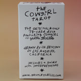 The back of the Cowgirl Tarot Deck on a pink and yellow background.