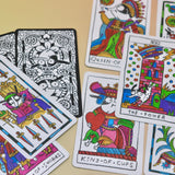 The cards from the Cowgirl Tarot Deck on a pink and yellow background.