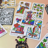 The cards from the Cowgirl Tarot Deck on a pink and yellow background.