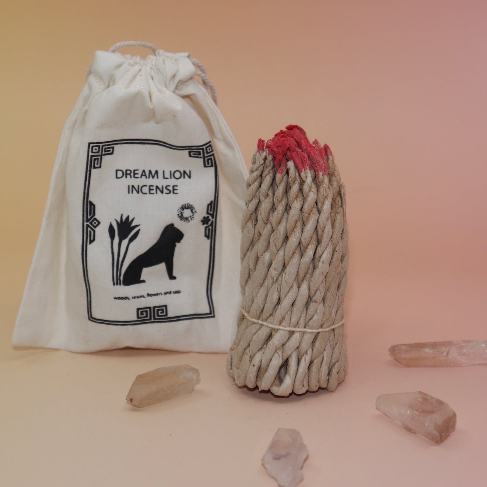 The Nepalese Himalayan Hand Rolled Incense Ropes next to its bag with crystal points surrounding it all on a light pink and yellow background.