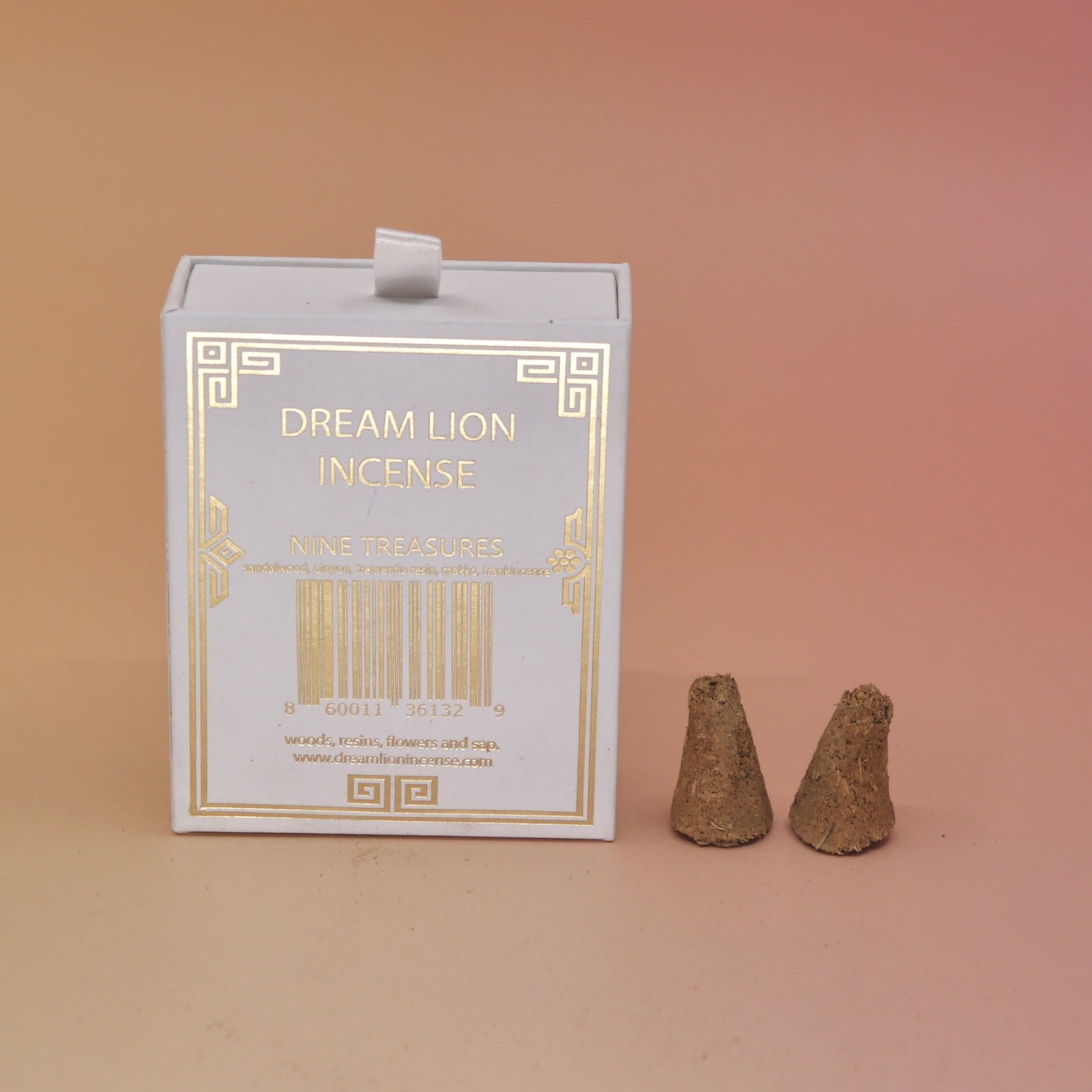 The back of the Nine Treasures Incense Cones box with two incense cones next to it, all on a pink and yellow background.