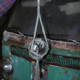 Someone holding the sage Disco Ball Hanger with Disco Ball in front of a vintage teal Volkswagen bus.