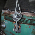 Someone holding the sage Disco Ball Hanger with Disco Ball in front of a vintage teal Volkswagen bus.