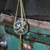 Someone holding the Chartreuse Disco Ball Hanger with Disco Ball in front of a vintage teal Volkswagen bus.
