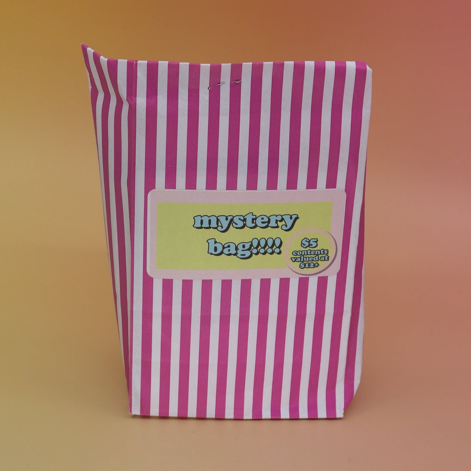 The 5 Dollar Blind Mystery Bag on a pink and orange background.