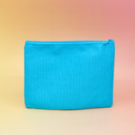 The back of the Me & My Lip Products Against The World Canvas Zipper Pouch on a pink and yellow background.