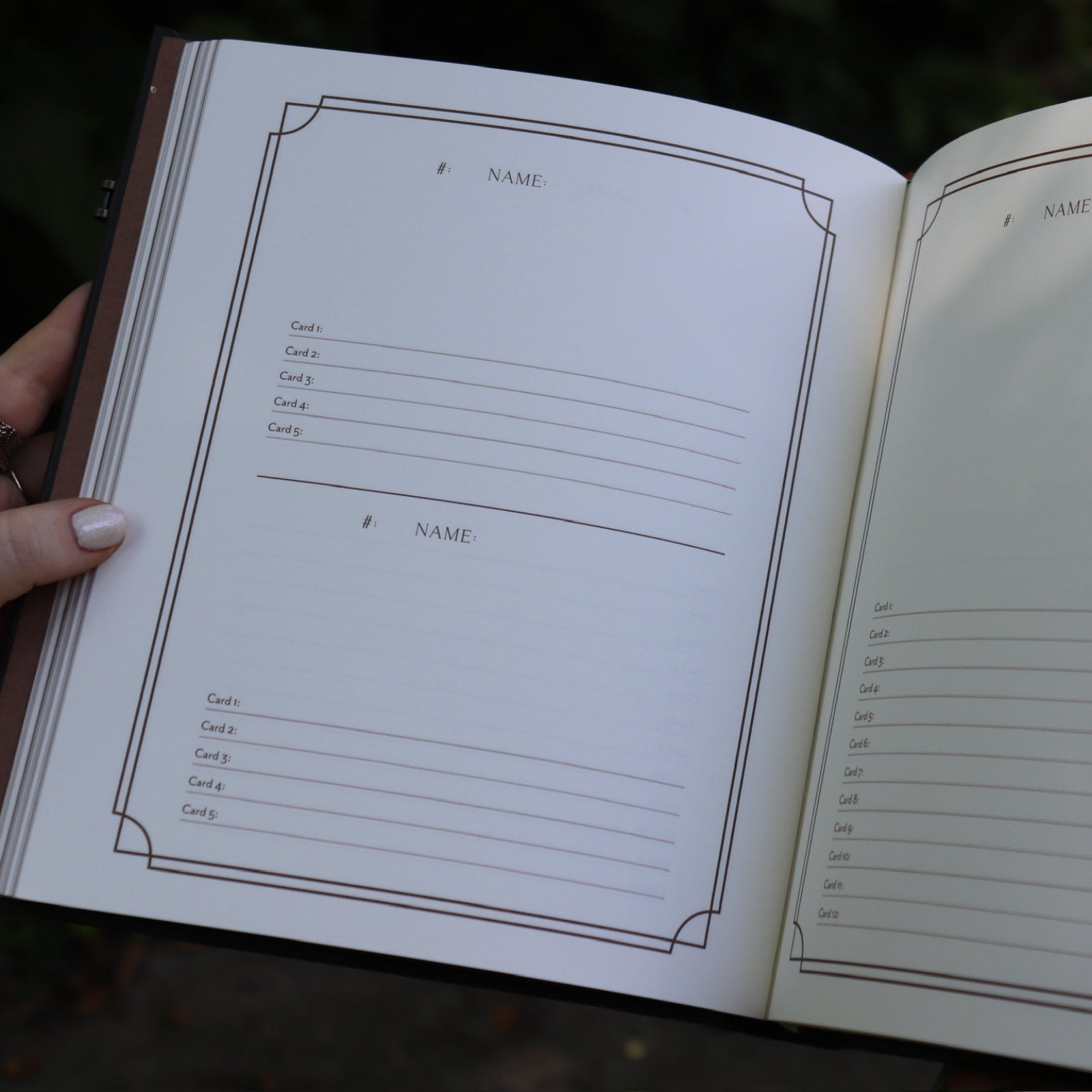 A woman holding the Complete Tarot & Oracle Journal Hardcover Book open to show off the pages.